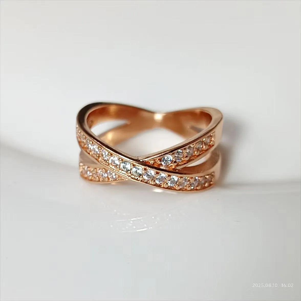 Silver or rose gold couple ring with micro-inlaid cross and geometric design on a copper band.