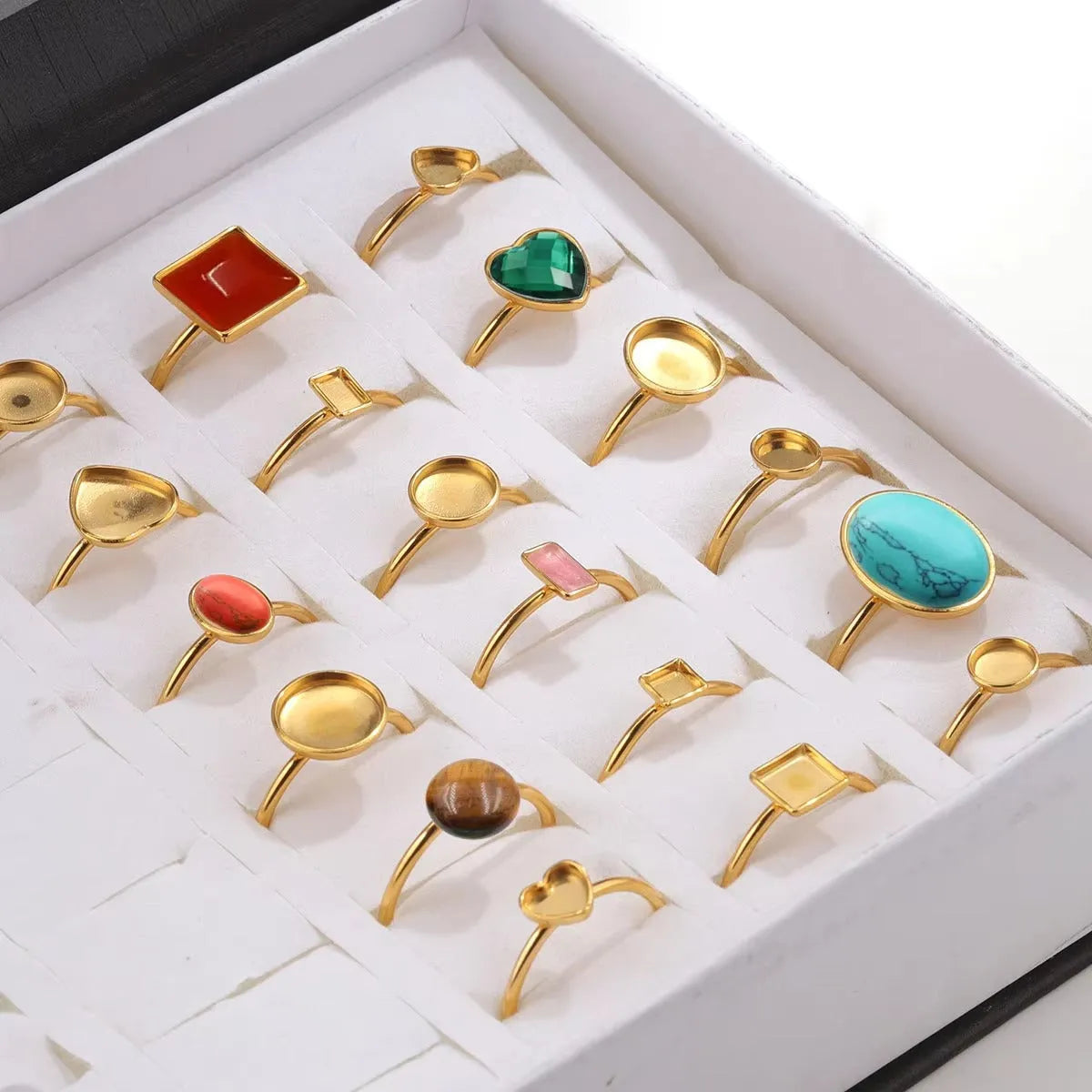 Golden stainless steel ring settings in various shapes including oval, round, square, rectangle, and heart designs