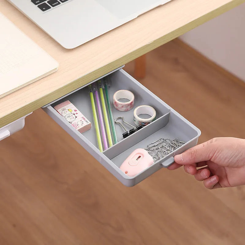 White adhesive under desk storage drawer with lid open, showing interior grid divider.