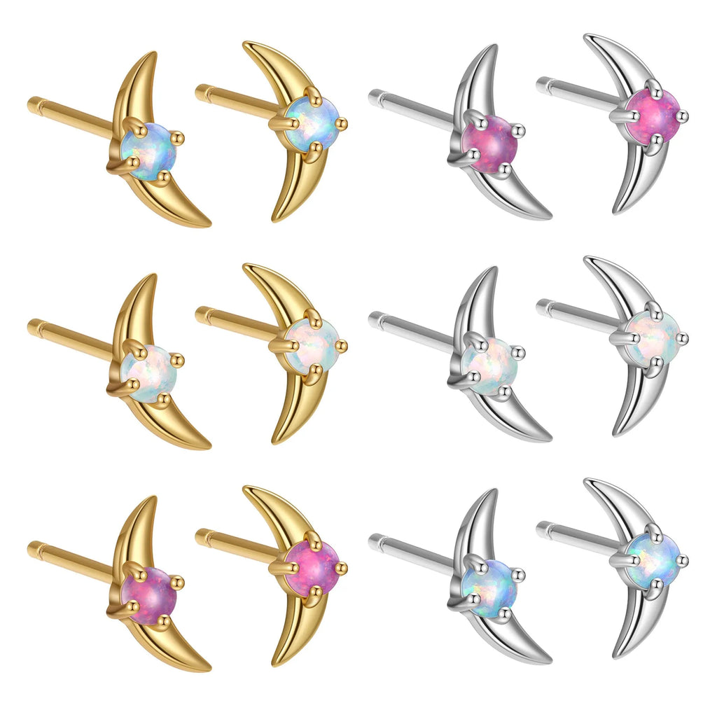 Women's geometric 925 silver earrings with blue stone in gold setting.
