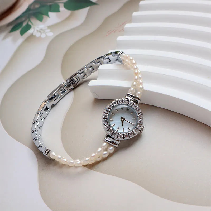 Women's light gold freshwater pearl bracelet watch with 18mm round dial and stainless steel construction