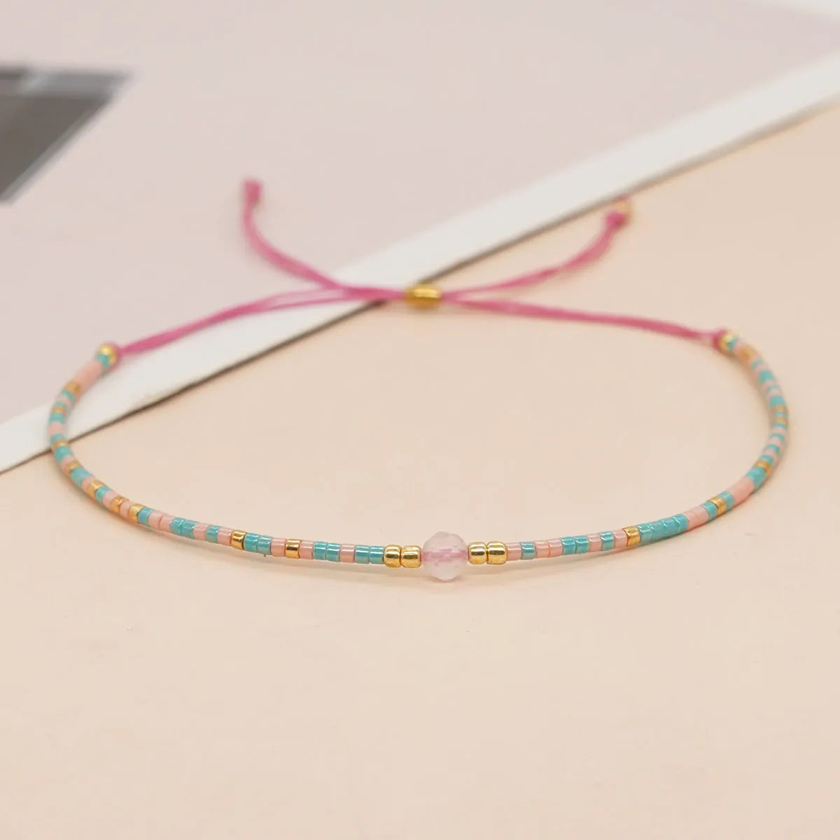 Handmade bohemian style bracelet with colourful geometric glass and coloured glaze beads.