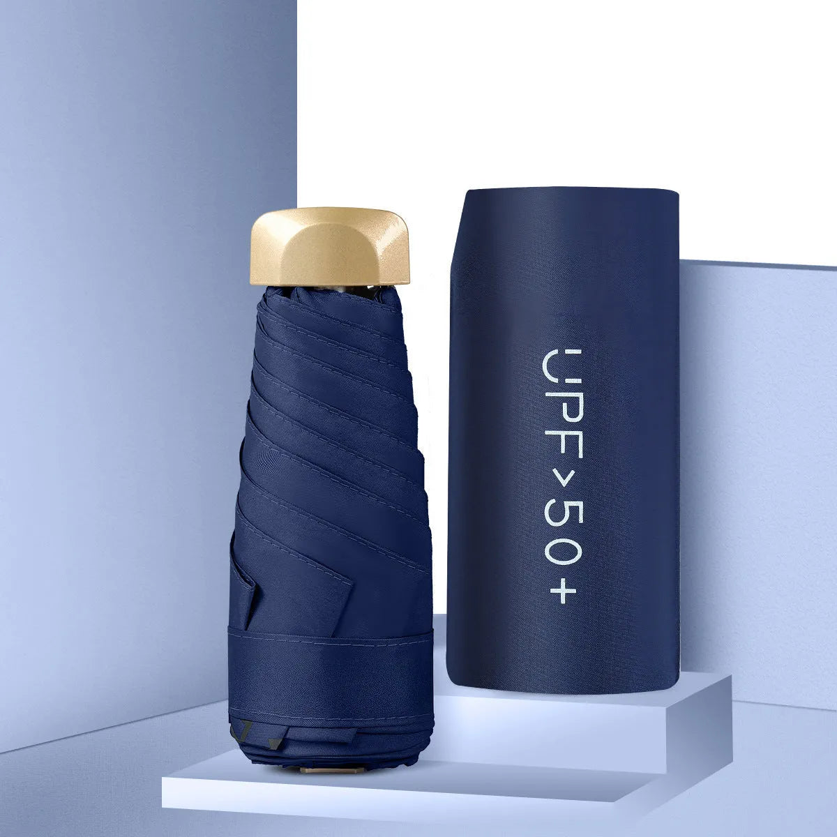 Closed black five-fold mini pocket sun umbrella with rubber handle showing compact size.