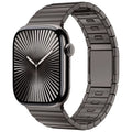 Silver stainless steel Apple Watch strap with magnetic buckle on a wrist, showing business style design.