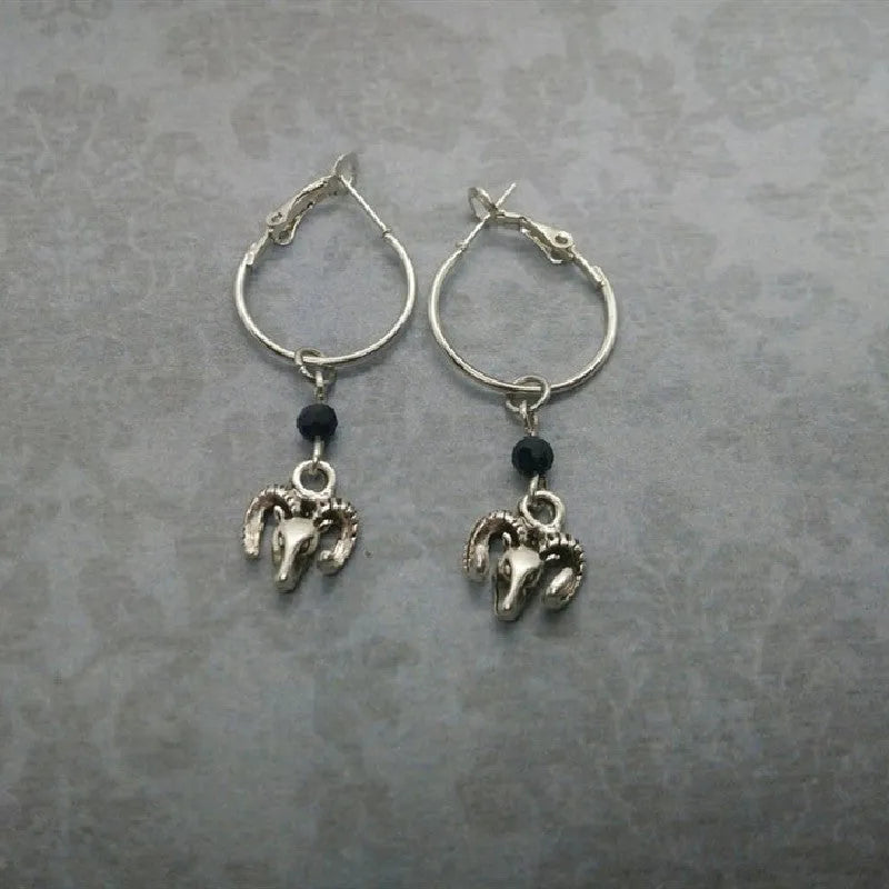 Silver coloured round ring earrings with Tibetan antelope design inspiration