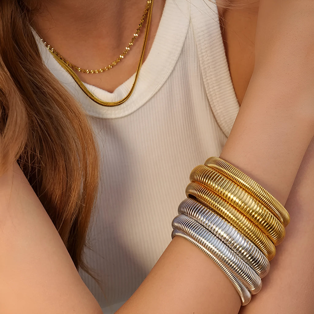 Gold titanium steel bracelet with elastic band and exaggerated vertical stripe ring design