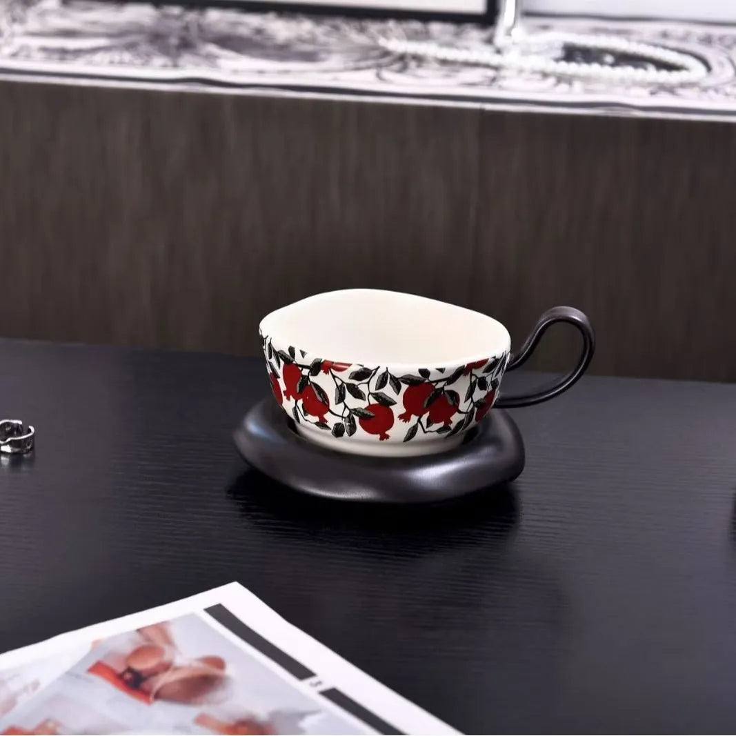 Antique style ceramic coffee cup and saucer set with medieval decoration in black or orange