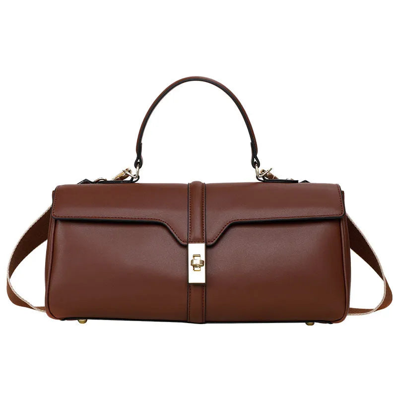 Women's solid colour cowhide leather messenger bag in black, cylindrical shape, with crossbody strap