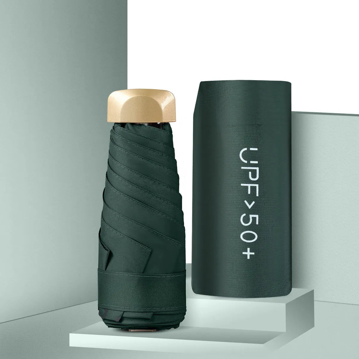 Closed black five-fold mini pocket sun umbrella with rubber handle showing compact size.