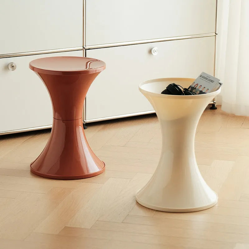 Hourglass-shaped plastic stool in green for changing shoes, used by an adult and child.