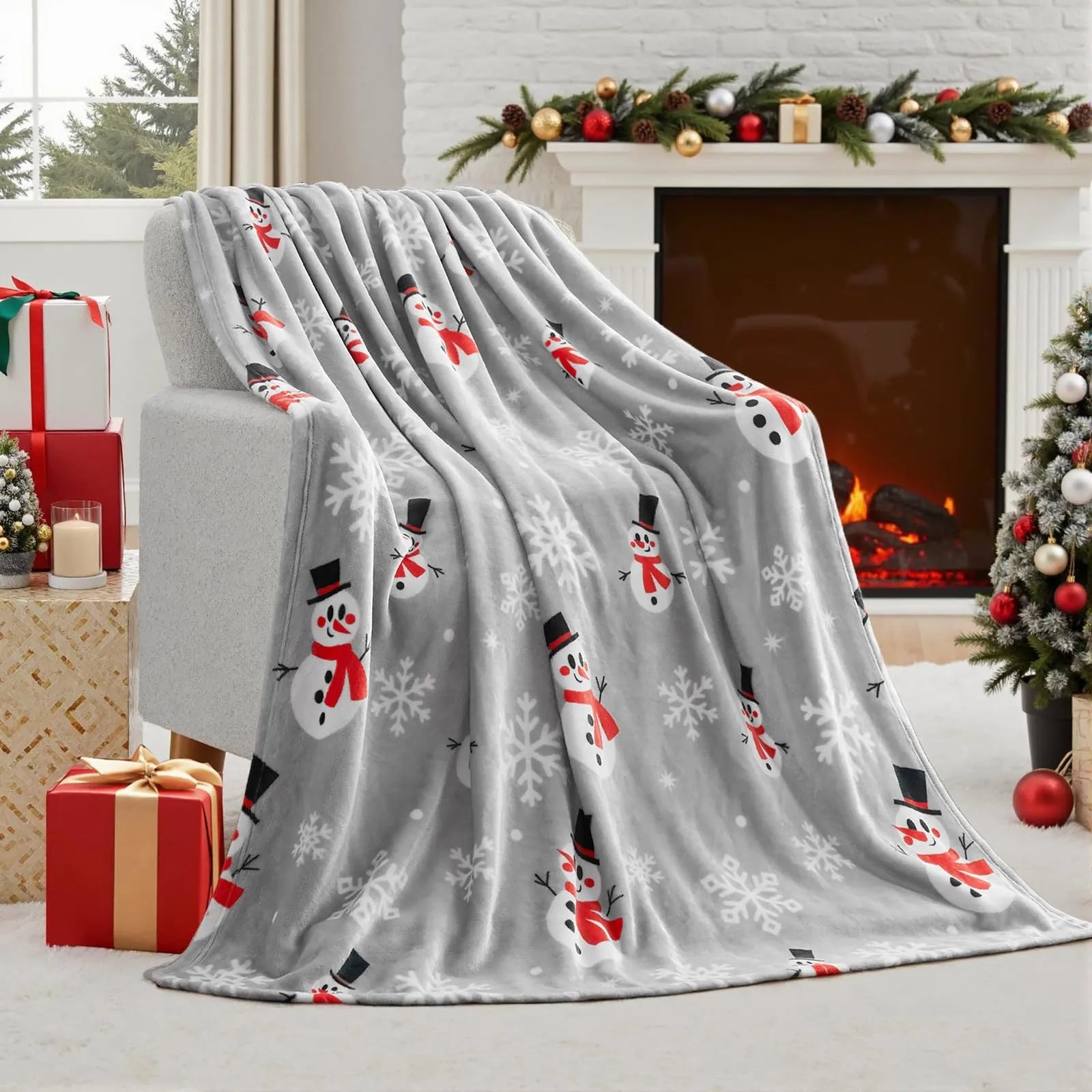 Soft red polyester flannel Christmas blanket with festive pattern draped over a bed