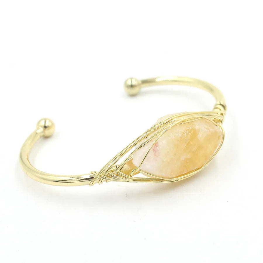 Natural raw gemstone winding bracelet with amethyst, pink crystal, and green fluorite stones on a string with a clasp.
