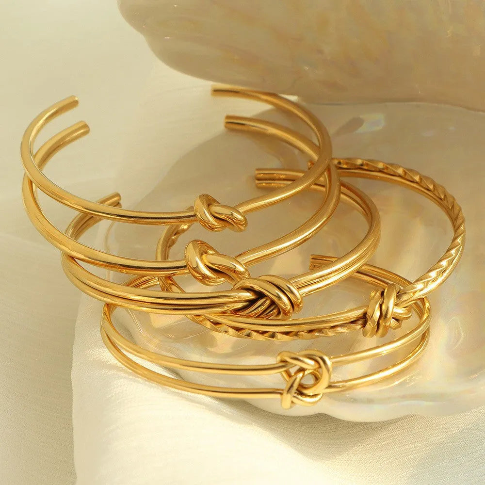 Adjustable C-shaped open double-layer women's bracelet with a knotted clasp in gold or silver finish.