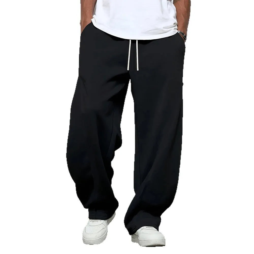 Men's straight-leg casual trousers in polyester with an elasticated waist, shown in black, grey and light grey.