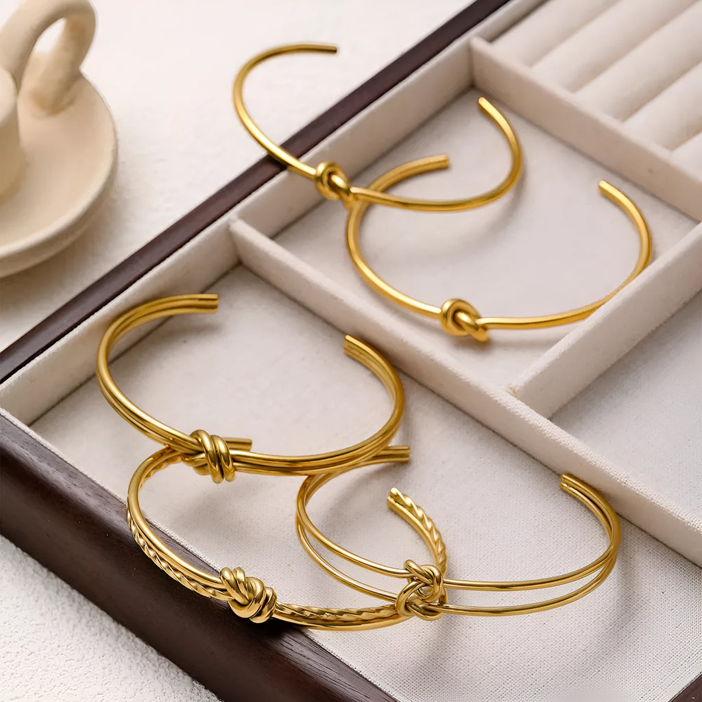 Adjustable C-shaped open double-layer women's bracelet with a knotted clasp in gold or silver finish.