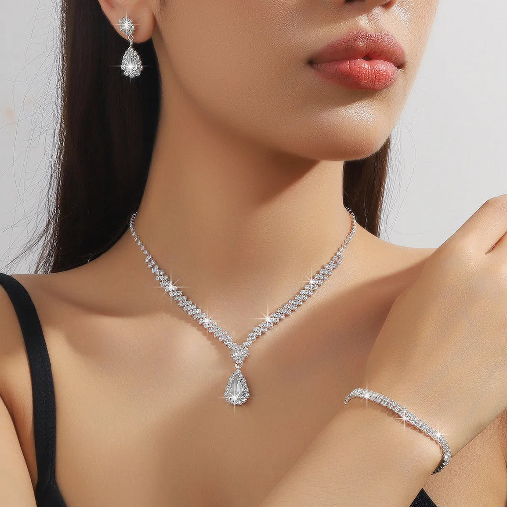 Claw chain necklace and matching drop earrings set with rhinestones in multiple colours.