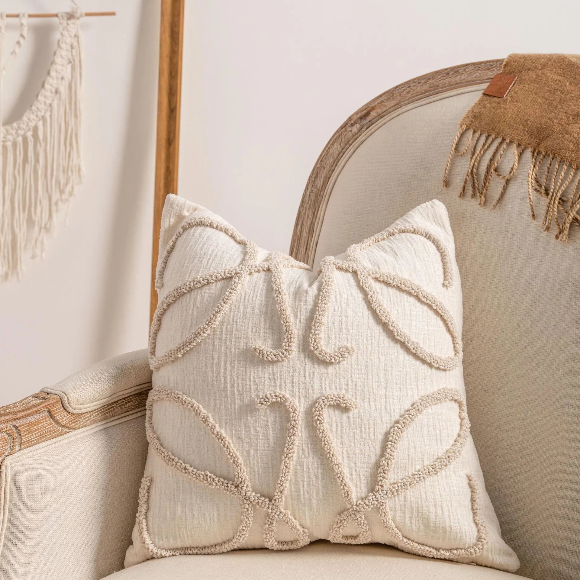 Knitted cushion cover with tassel trim in a printed spiral dots pattern, shown in 45x45cm size.