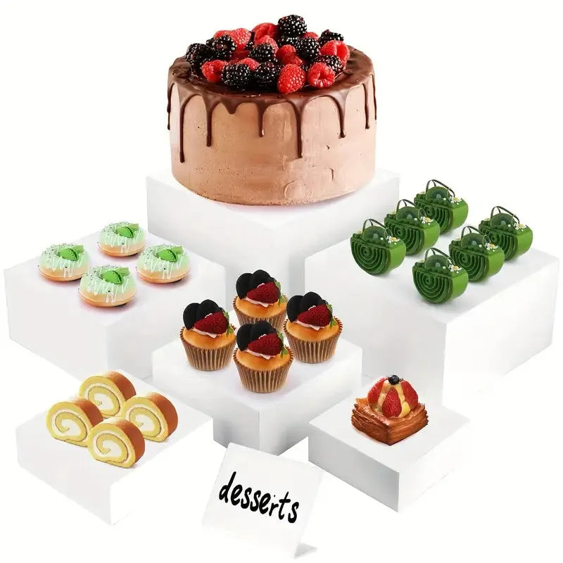Set of six white plastic cube units forming a tiered desktop dessert display stand.