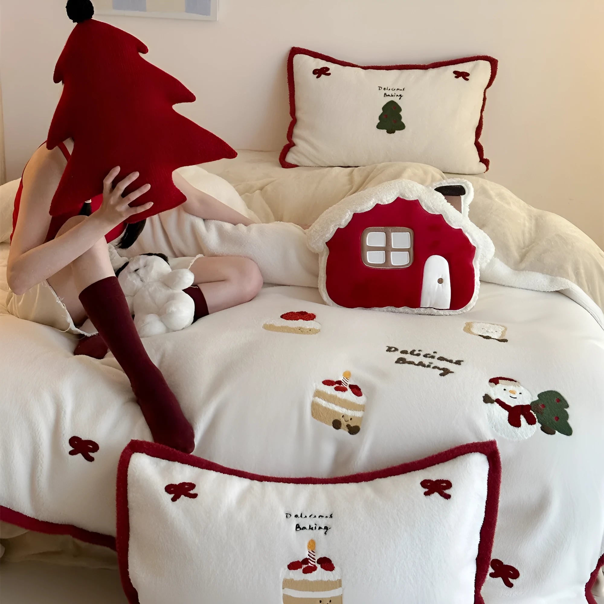 Girl's cartoon winter Christmas themed bedding four-piece set with duvet cover, sheet and pillowcases on a bed.