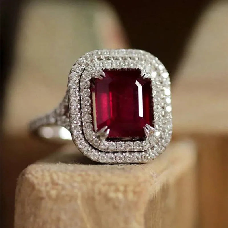 Women's geometric square copper ring with crystal rhinestones in red, showing princess design