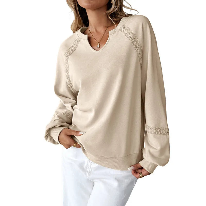 Women's loose-fit sweater in apricot with a half-open collar, lace stitching detail, and long sleeves.