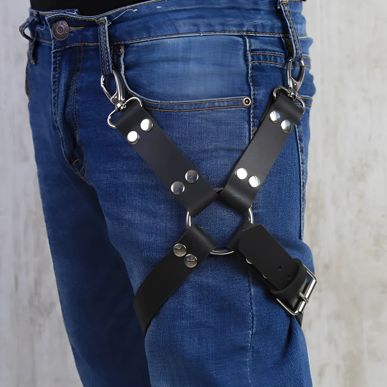 Black PU leather leggings with leather accessories attached to the legs