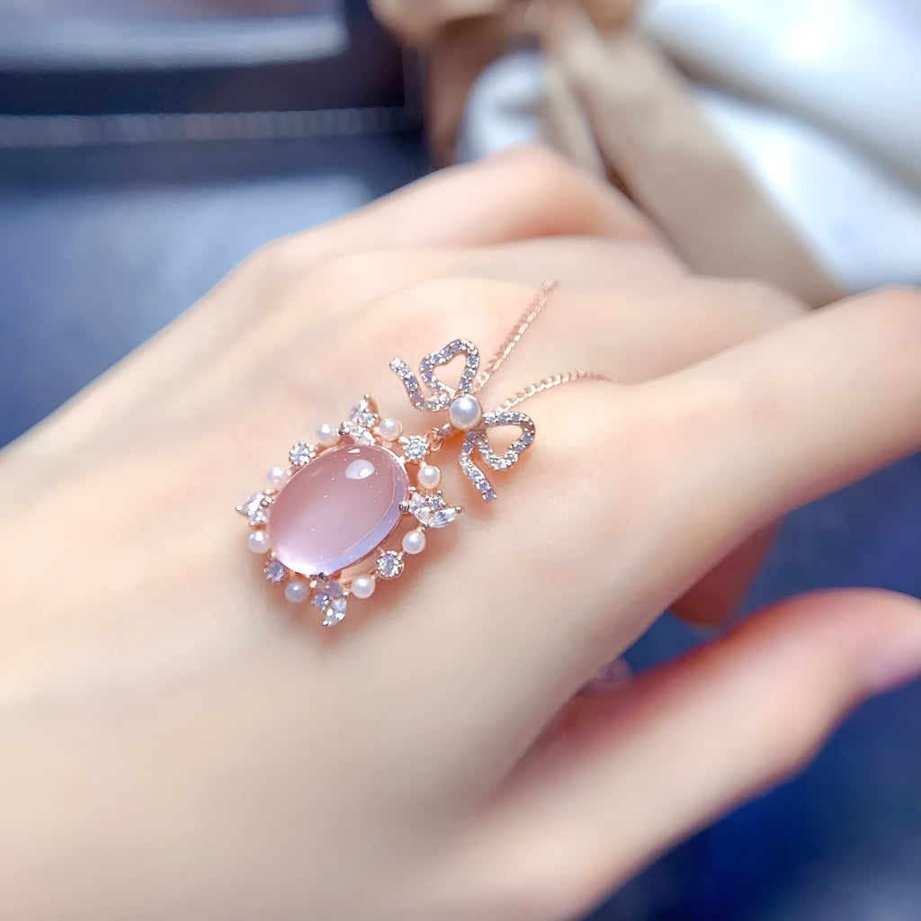 Pink rose quartz geometric pendant on a silver and rose gold plated necklace chain.