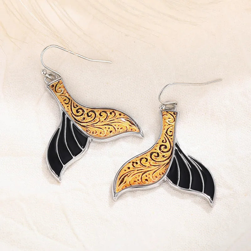 Women's white gold fishtail earrings with whale elements and retro styling