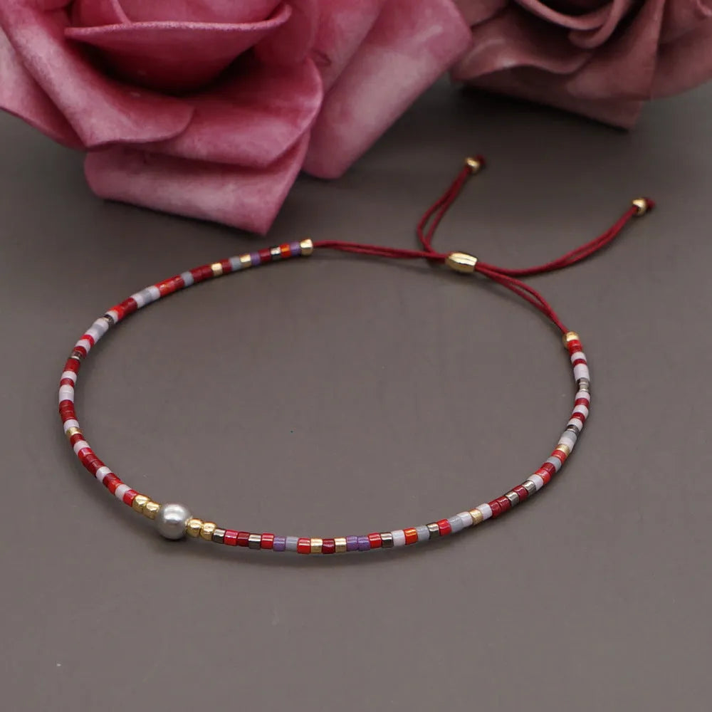 Handmade bohemian style bracelet with colourful geometric glass and coloured glaze beads.
