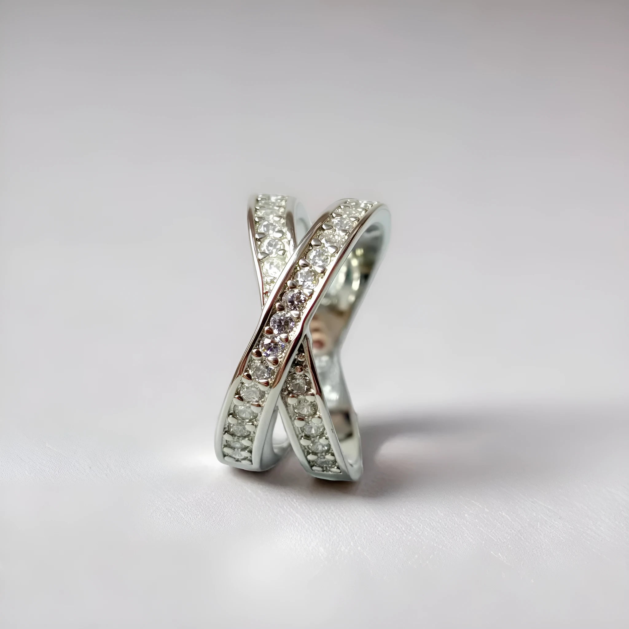 Silver or rose gold couple ring with micro-inlaid cross and geometric design on a copper band.