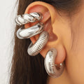 Geometric gold and silver ear clips for women without pierced ears showing exaggerated shape design