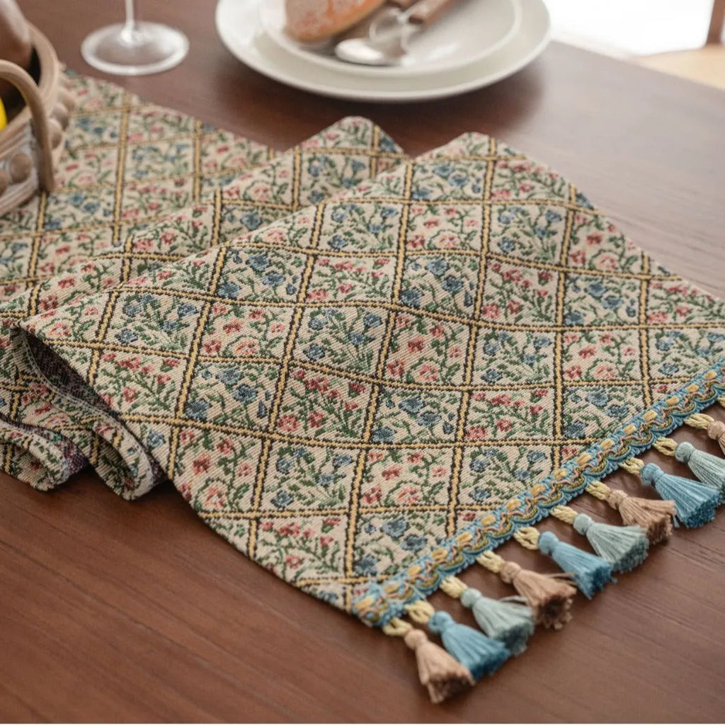 Nordic jacquard bouquet pattern table runner with striped design and decorative tassel fringe in dark blue