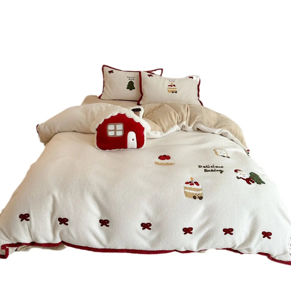 Girl's cartoon winter Christmas themed bedding four-piece set with duvet cover, sheet and pillowcases on a bed.