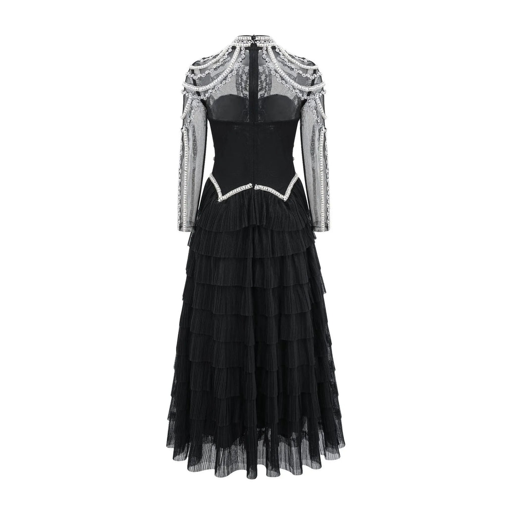 Black long sleeve women's dress with detailed beaded decoration on the bodice.