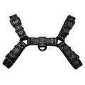 Black leather chest muscle bondage strap with silver metal buckles and rivets laid flat.