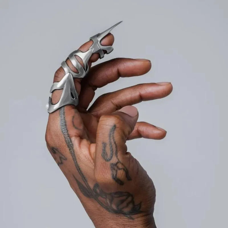 Silver alloy finger stall ring for punk and medieval armour costumes on a finger.