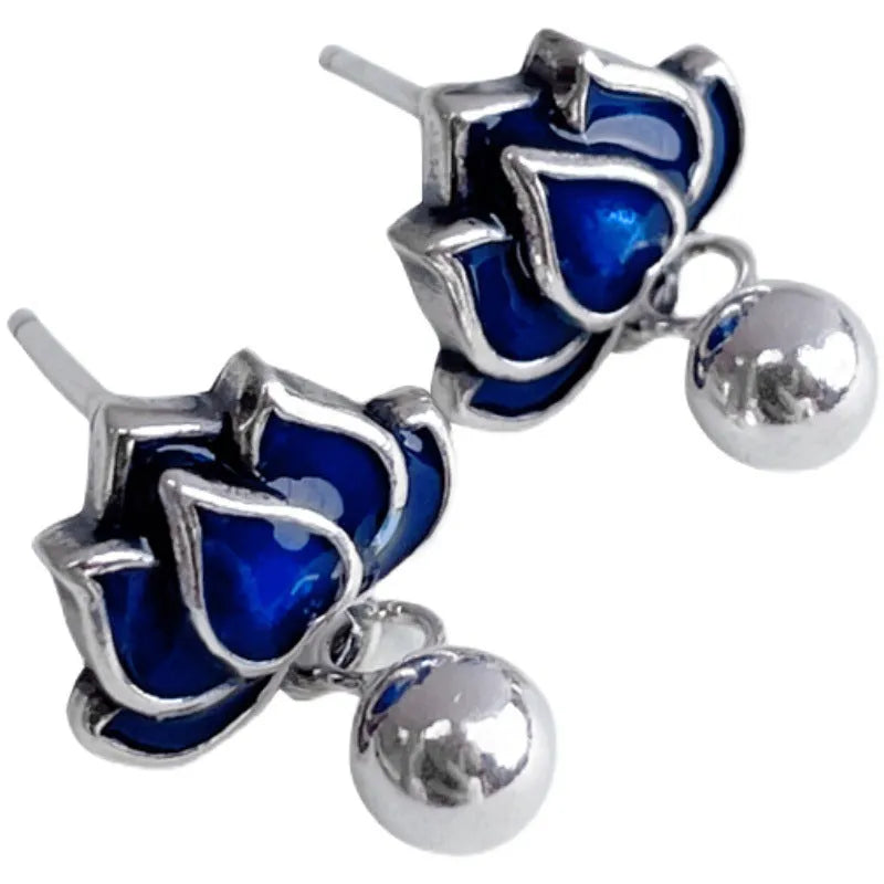 Blue lotus seedpod earrings with artistic tassel detailing on flower-shaped 1.2cm studs