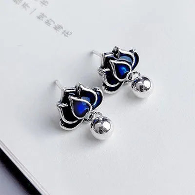 Blue lotus seedpod earrings with artistic tassel detailing on flower-shaped 1.2cm studs