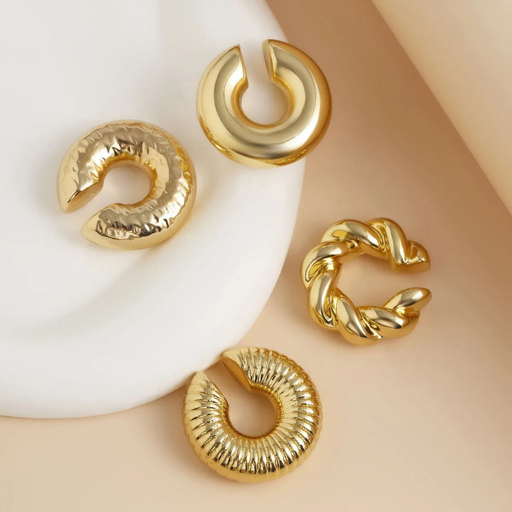 Geometric gold and silver ear clips for women without pierced ears showing exaggerated shape design