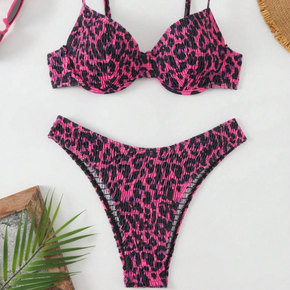 Women's leopard print bikini set with backless top and briefs bottom in brown and red colour options.