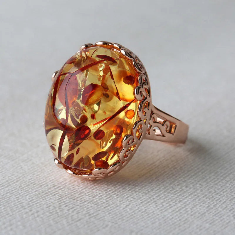 Close-up of a retro-style amber ring with beeswax inclusion, in New Amber Type A colour, on an alloy band.