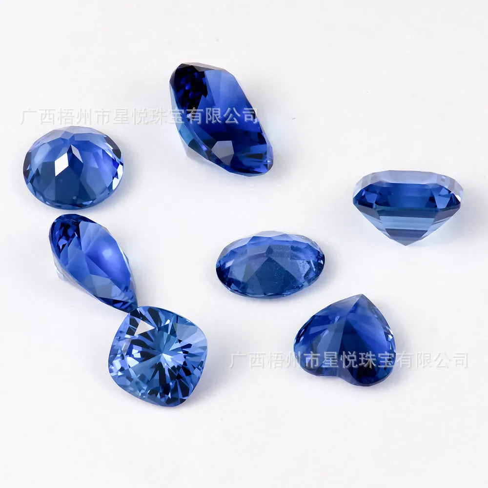 Royal blue cubic zirconia loose gemstone in a heart shape cut on a plain background.
