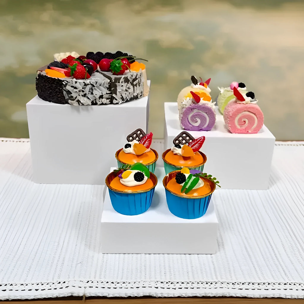 Set of six white plastic cube units forming a tiered desktop dessert display stand.