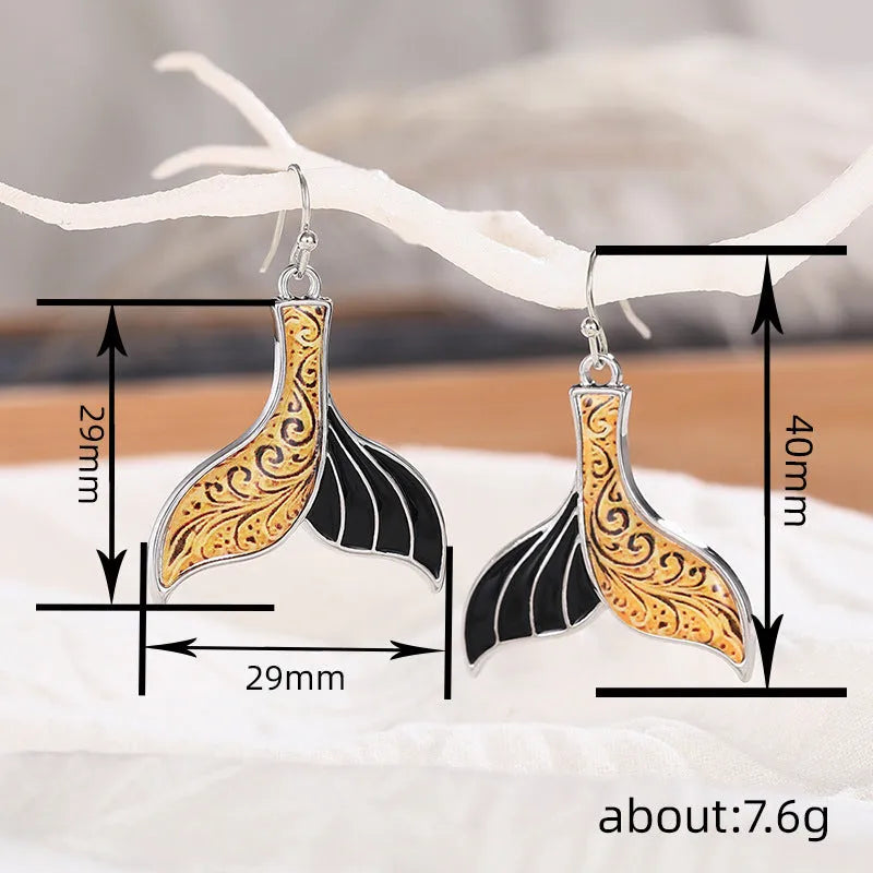 Women's white gold fishtail earrings with whale elements and retro styling