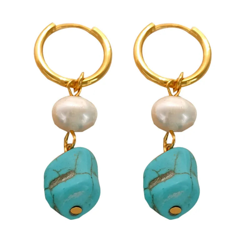A pair of geometric turquoise and cultured pearl clip-on earrings on a copper setting.