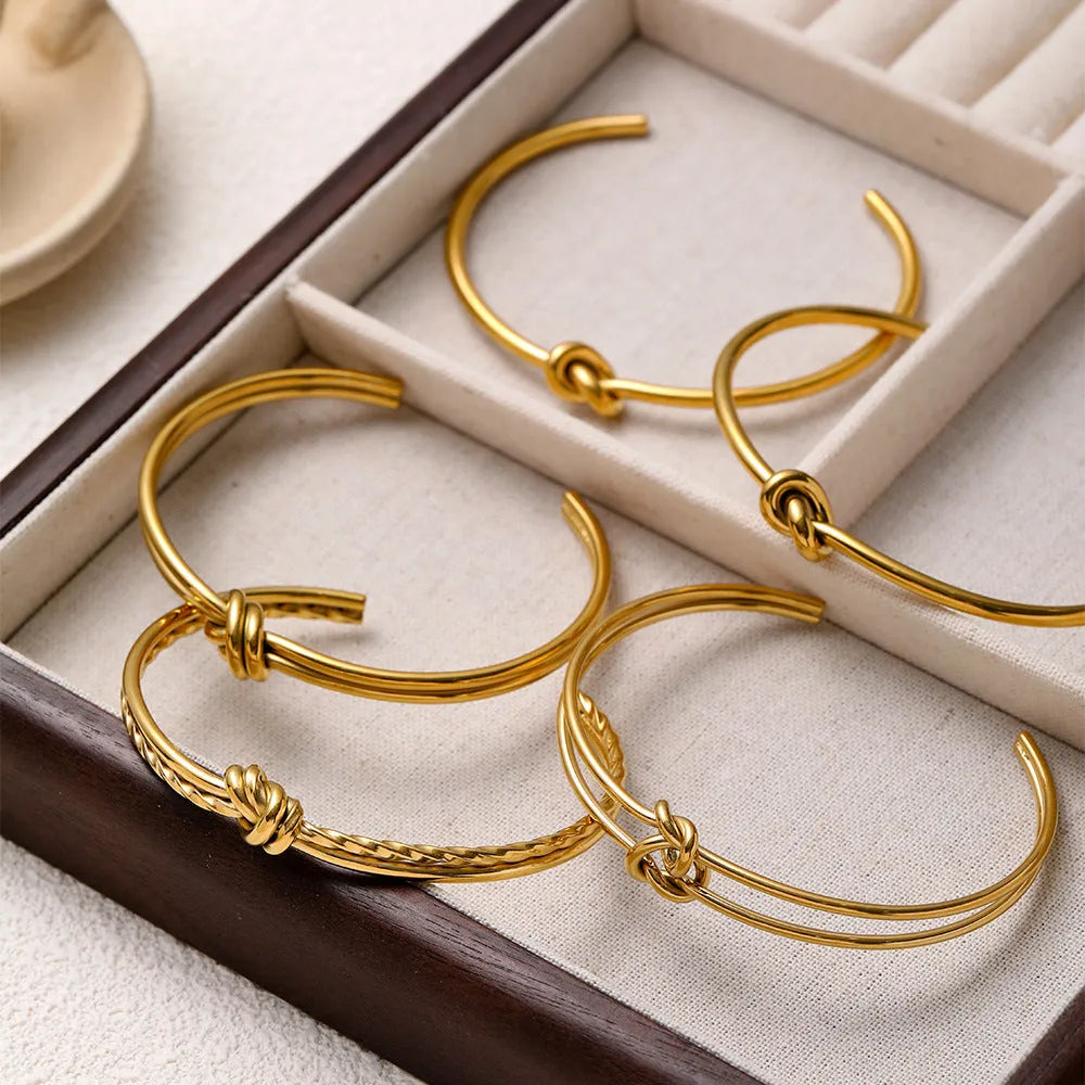 Adjustable C-shaped open double-layer women's bracelet with a knotted clasp in gold or silver finish.
