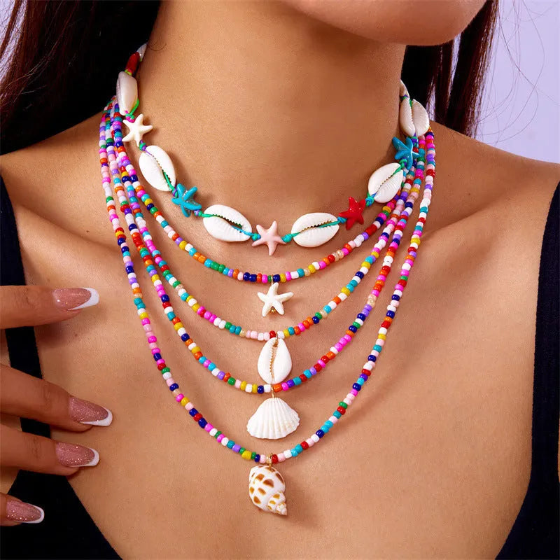 Five multi-layer shell bead necklaces with adjustable chains in blue and mixed colours