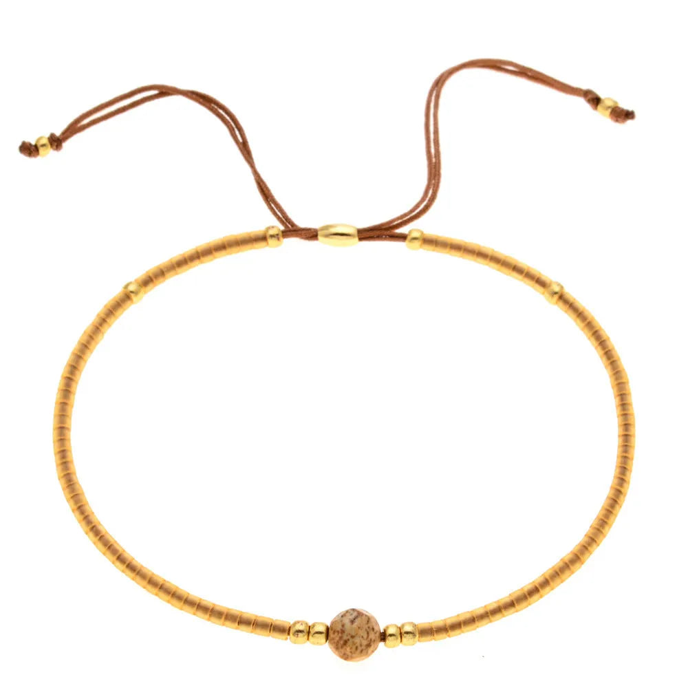 Handmade bohemian style bracelet with colourful geometric glass and coloured glaze beads.