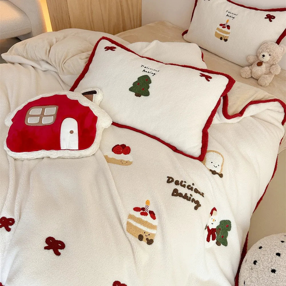 Girl's cartoon winter Christmas themed bedding four-piece set with duvet cover, sheet and pillowcases on a bed.