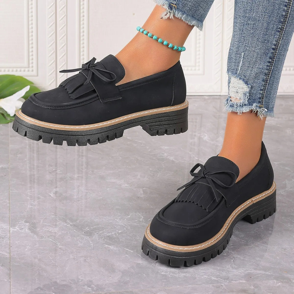 Plus size women's black loafers with tassel decoration and bowknot detail on round toe